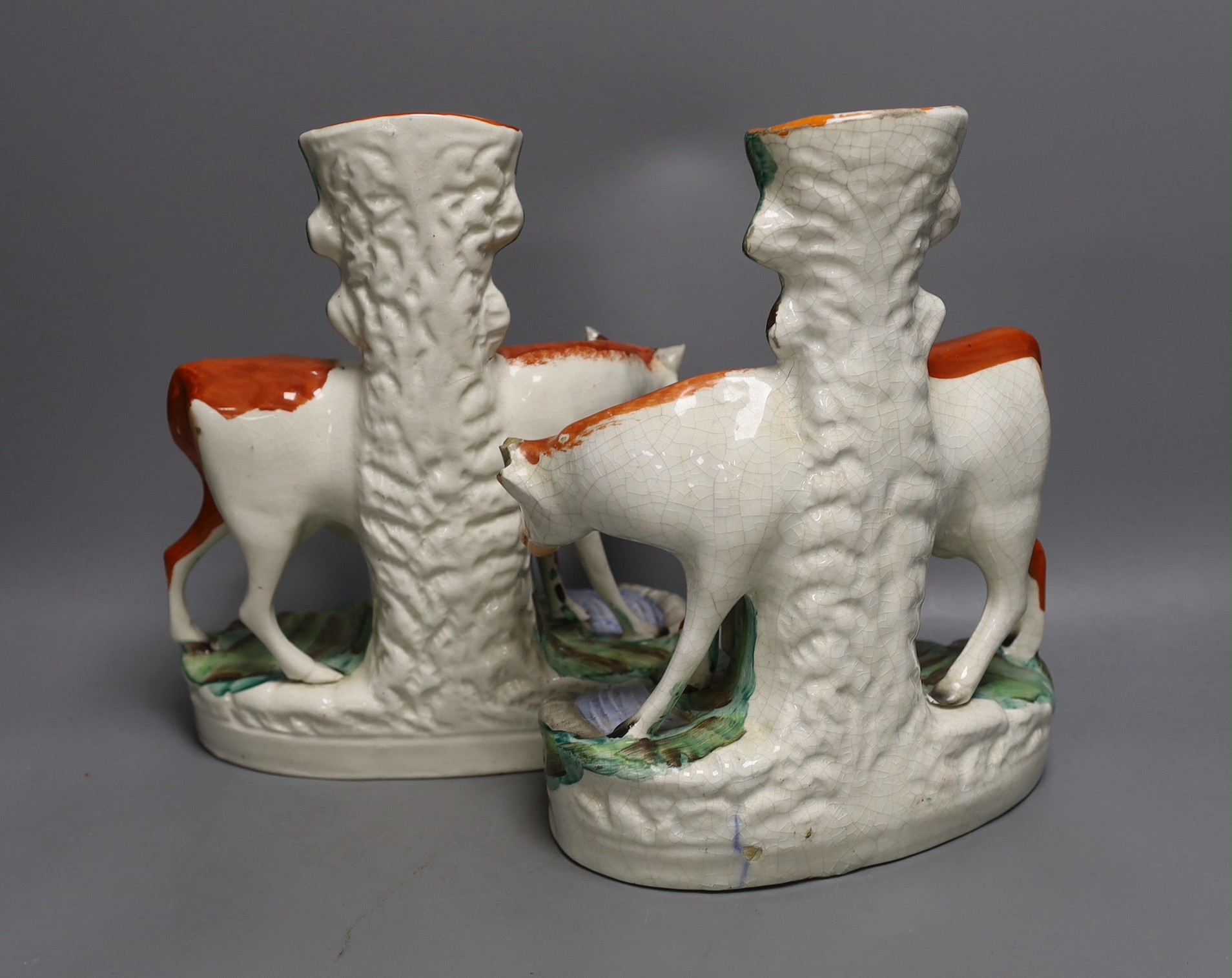 A pair of large Mid 19th century Staffordshire ‘cow and calf’ spill vases, 29cm